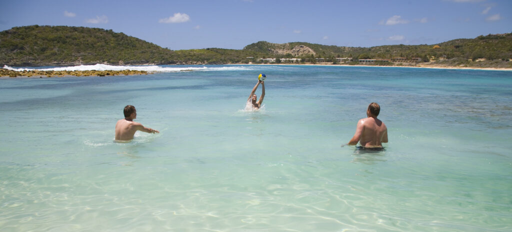 Swimmers in the calm, shallow water of Half Moon Bay, Antigua