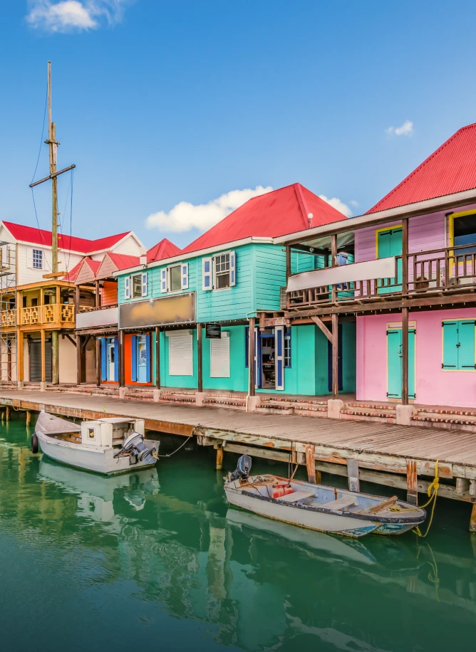 Colourful waterfront buildings and wooden boardwalk with small boats