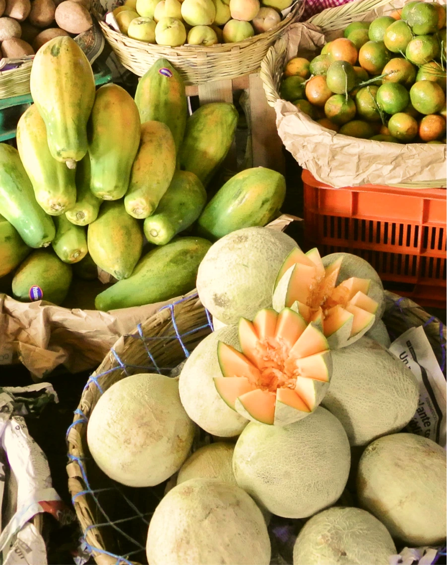 Fresh papayas and melons in baskets at a local market