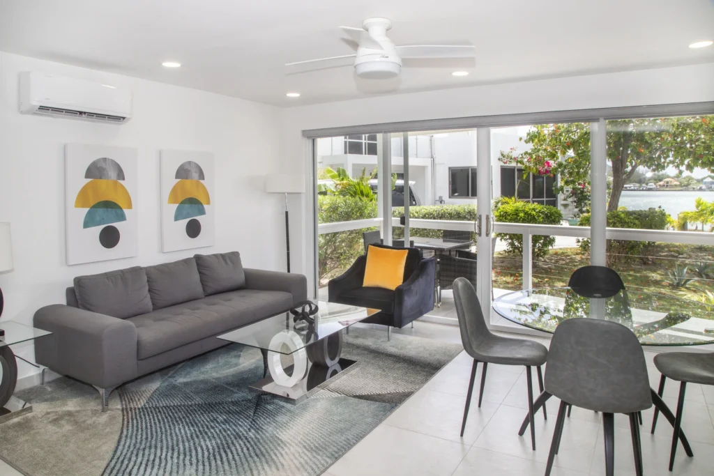 One Bedroom Superior villa open-plan living and dining area with patio doors