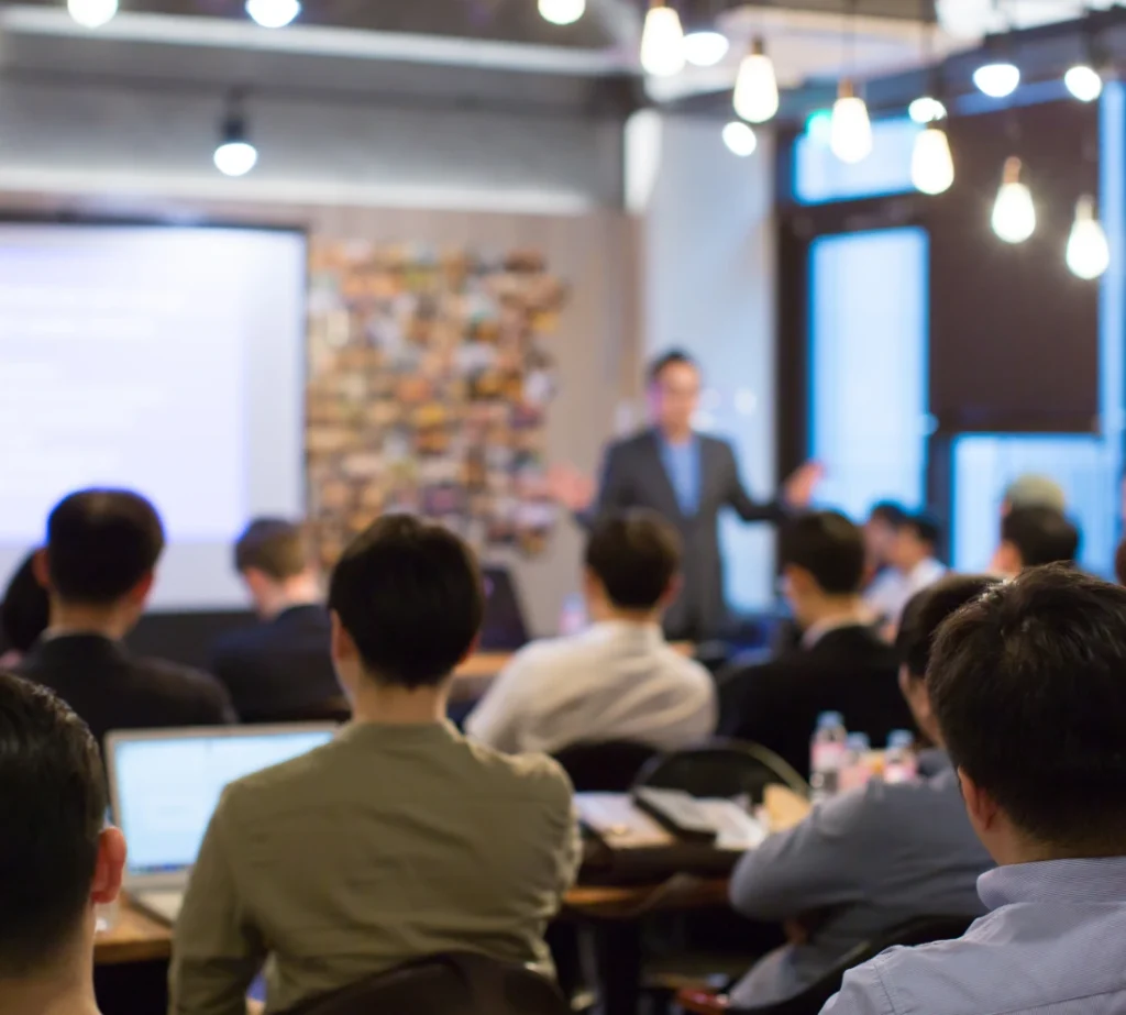 Speaker presenting to attendees at a business conference