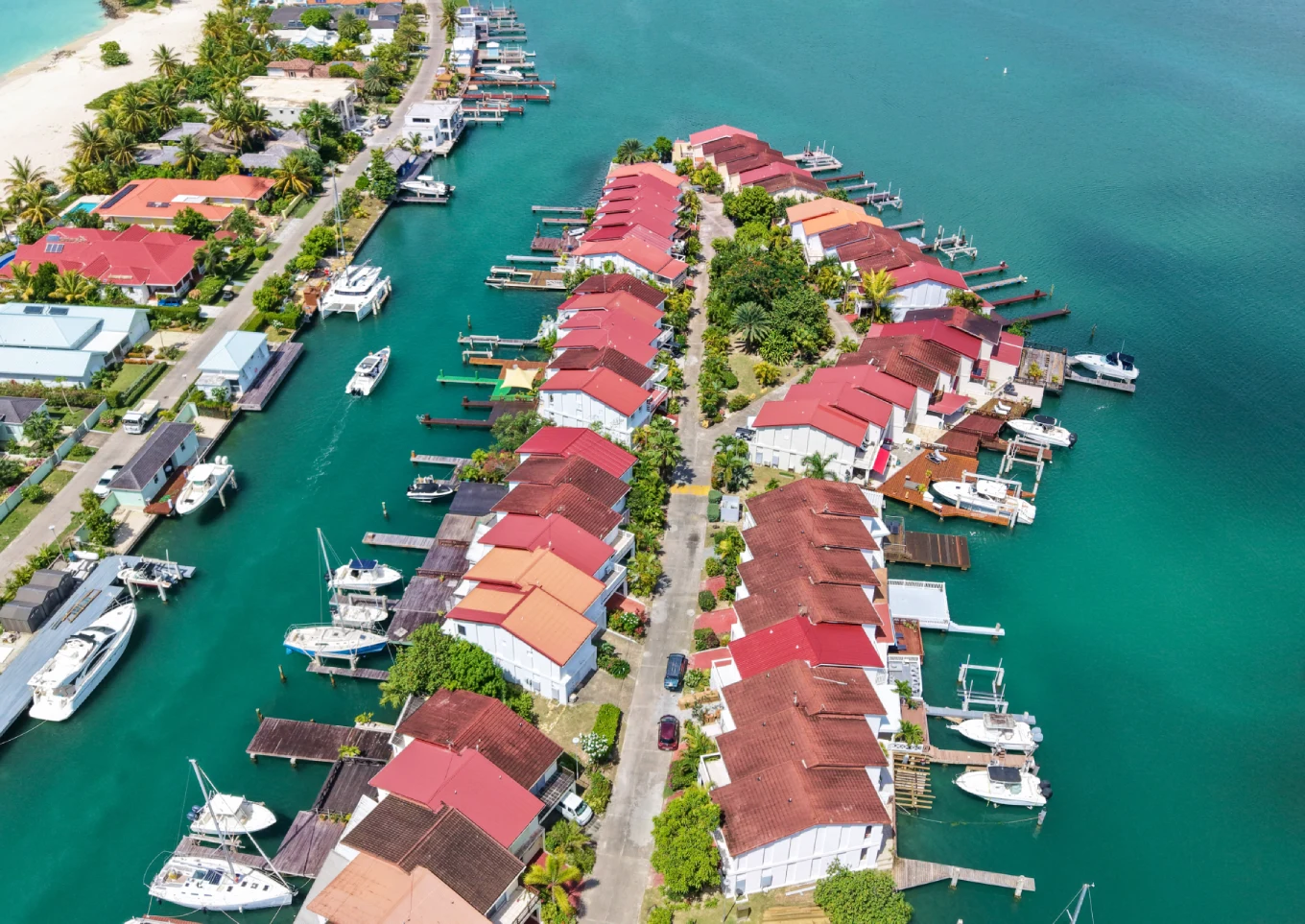 Aerial view of waterfront villas with private boat docks in Jolly Harbour